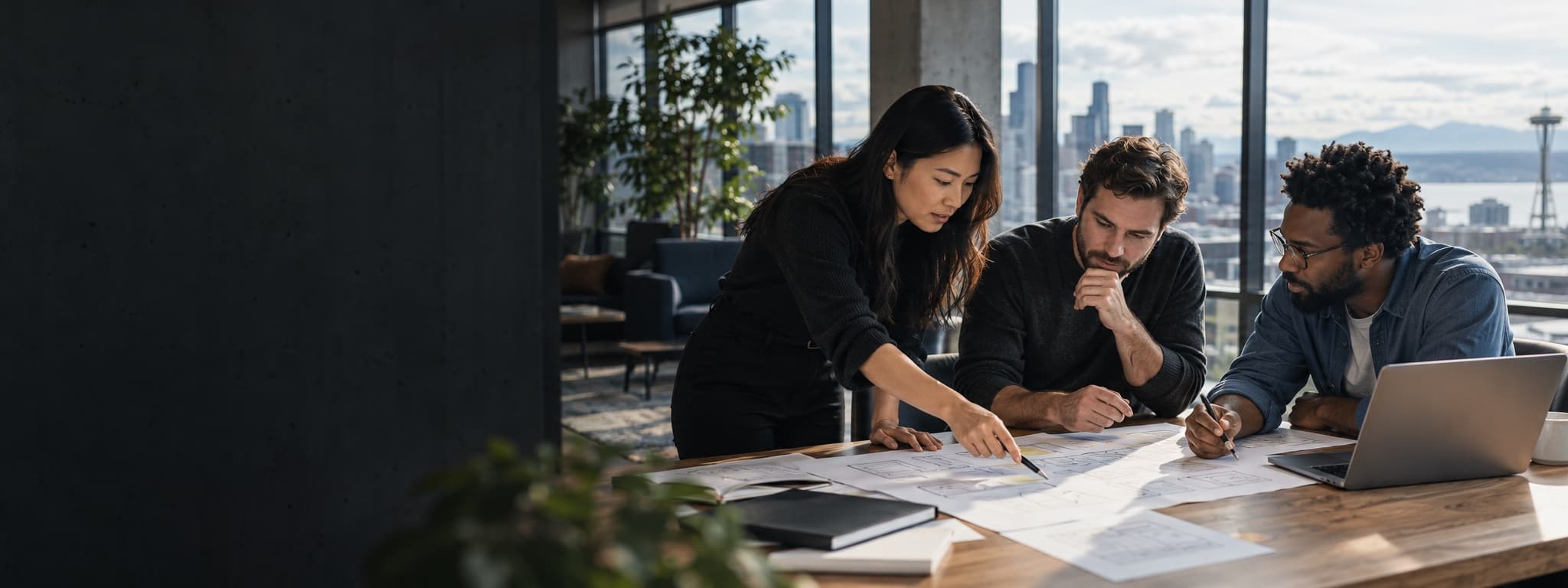 A three-person team mapping a business workflow together in a Seattle studio